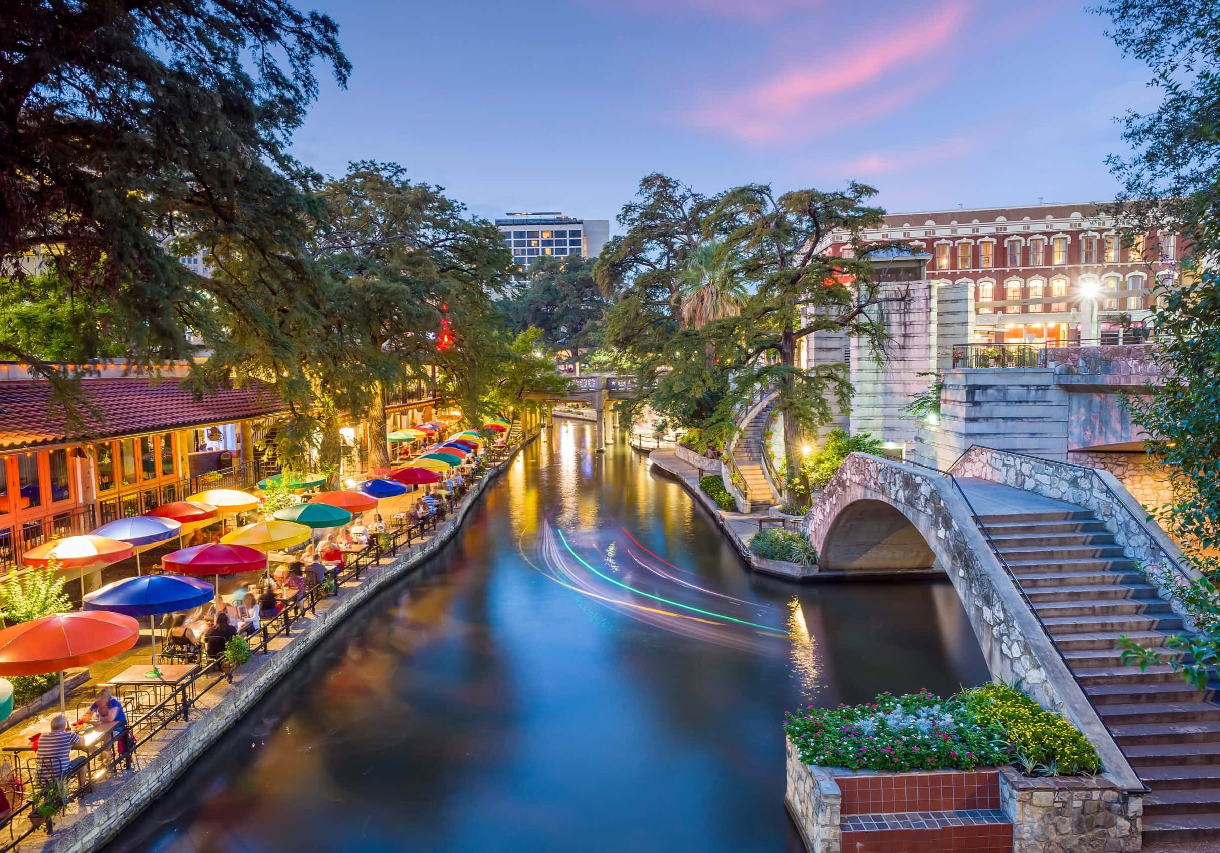 River walk in San Antonio city downtown skyline cityscape of Texas USA at sunset